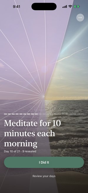 The app showing a sunset photo partly uncovered with a purple cover, on day 10 of a twenty one day meditation journey.